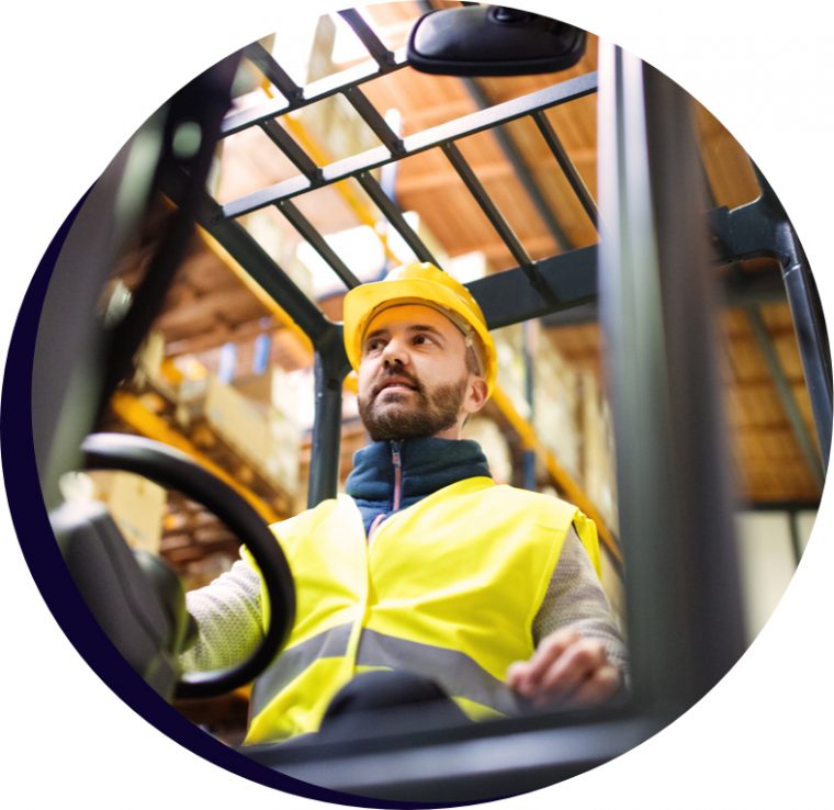 Man driving forklift wearing yellow hard hat